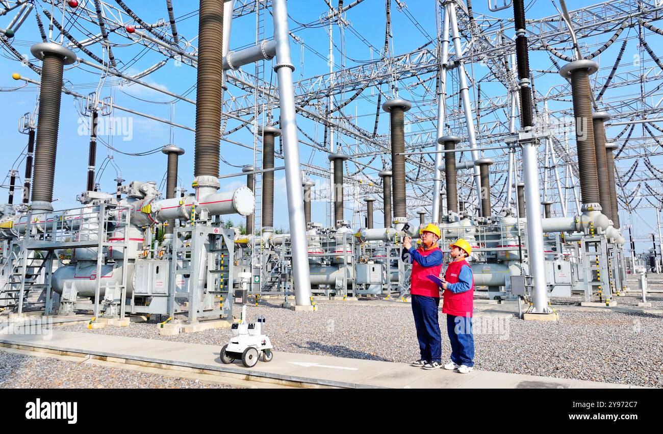 CHUZHOU, CHINE - 8 OCTOBRE 2024 - un robot intelligent et le personnel d'exploitation et de maintenance effectuent une inspection spéciale de l'équipement principal i. Banque D'Images