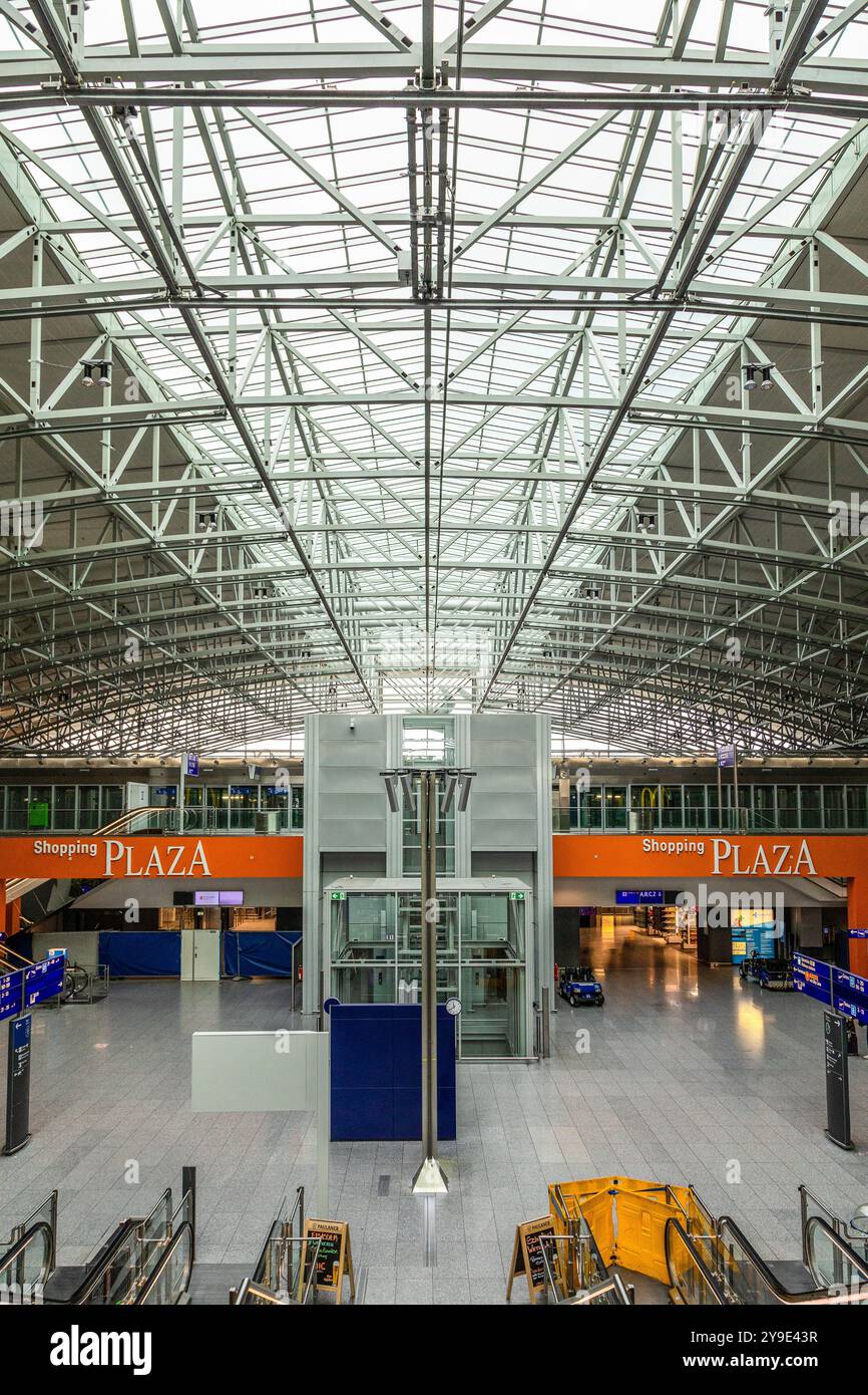 Aéroport de Francfort, Allemagne - 19 février 2024 : le vaste et moderne terminal 2 de l'aéroport dispose d'un toit métallique élevé et d'une place commerçante ouverte. Voyageurs c Banque D'Images