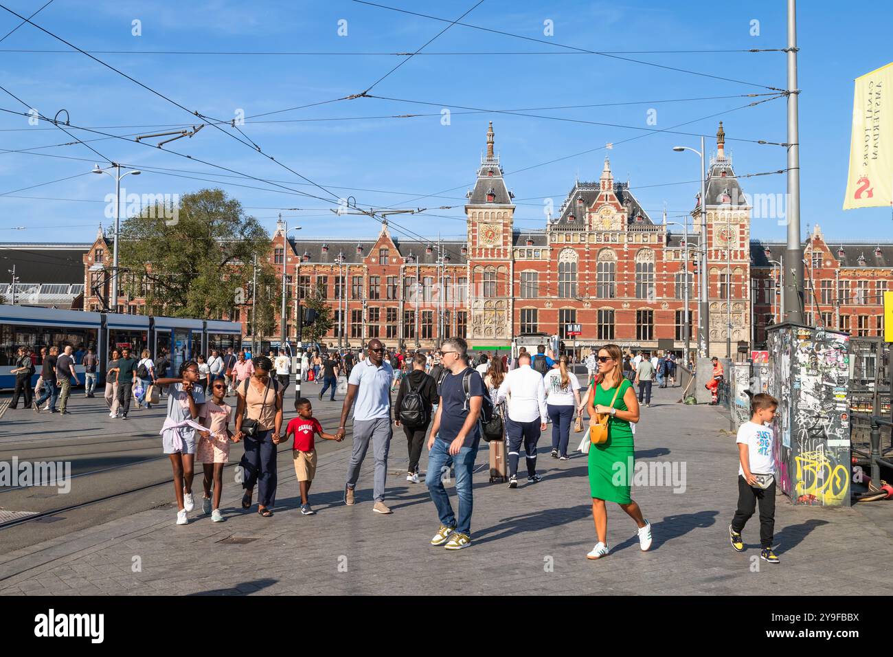 Les gens traversent le parvis de la gare centrale d'Amsterdam. Banque D'Images