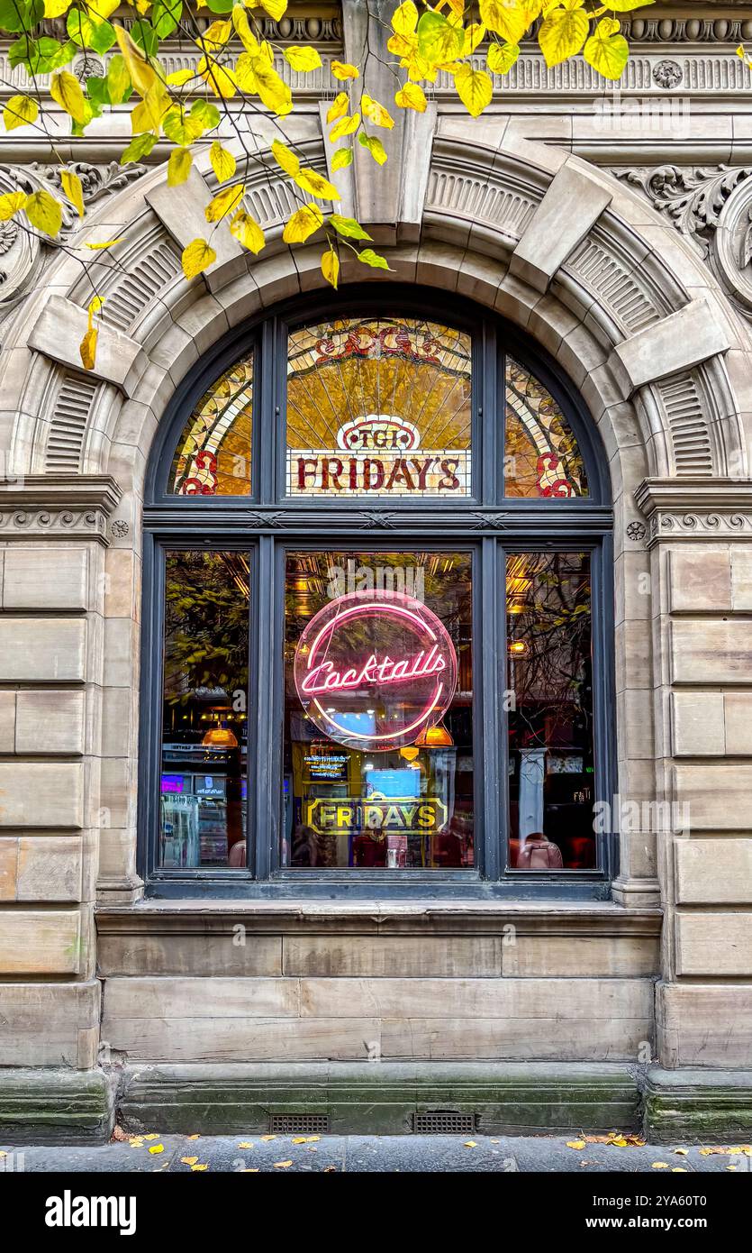 Les gens passant par la fenêtre de TGI Fridays Advertising cocktails, Buchanan Street, Glasgow, Écosse, Royaume-Uni Banque D'Images