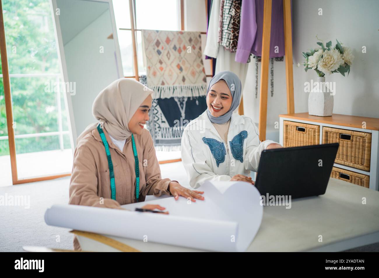 Deux femmes conceptrices musulmanes s'assoient ensemble tout en travaillant dans un atelier Banque D'Images