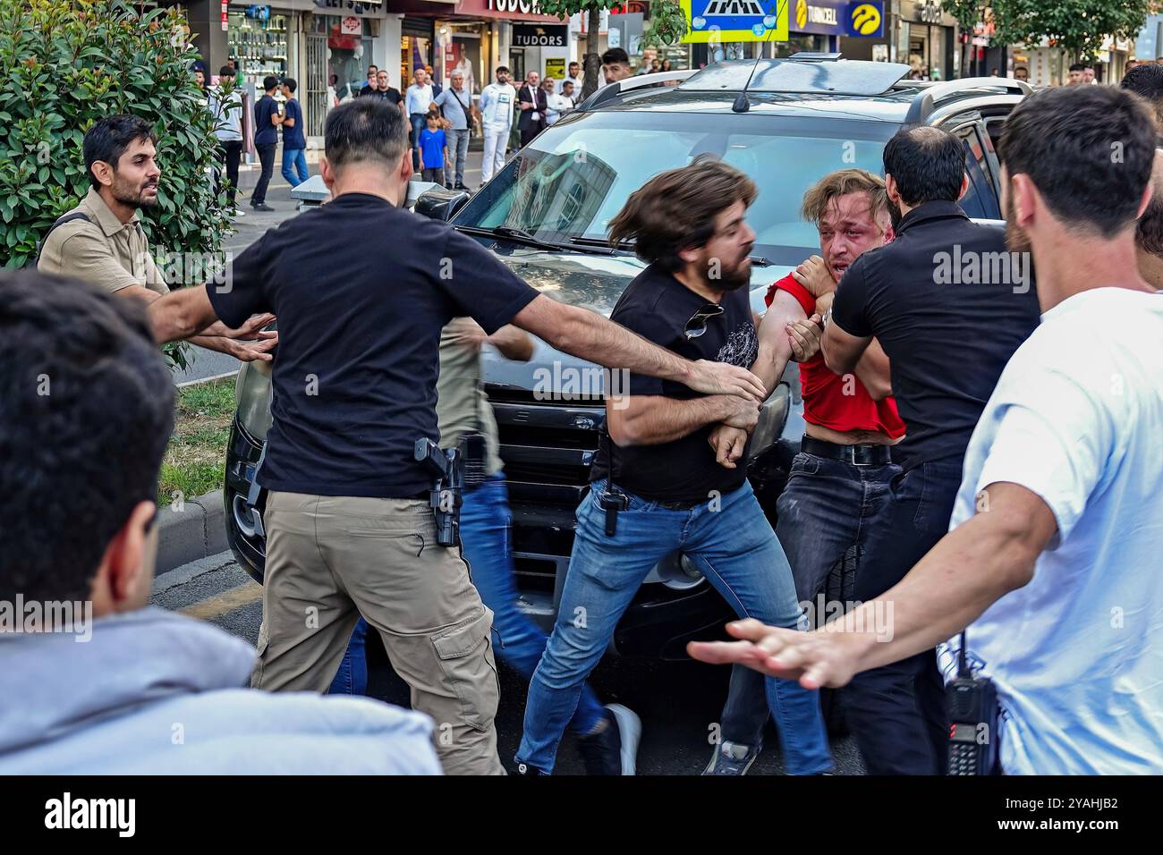 Un jeune kurde (en tissu rouge) est emmené dans une voiture de police après avoir été arrêté par la police turque après une déclaration à la presse. Les partis et organisations politiques kurdes n'ont pas été autorisés à organiser un « rassemblement de la Grande liberté » dans la ville de Diyarbakir pour la libération d'Abdullah Ocalan, le leader de l'organisation armée kurde, le Parti des travailleurs du Kurdistan (PKK), emprisonné depuis 25 ans, et pour la solution démocratique de la question kurde. À Diyarbakir, une foule de politiciens kurdes et des centaines de personnes se sont rassemblées devant AZC Plaza dans le centre-ville et ont voulu marcher jusqu'à la place Banque D'Images