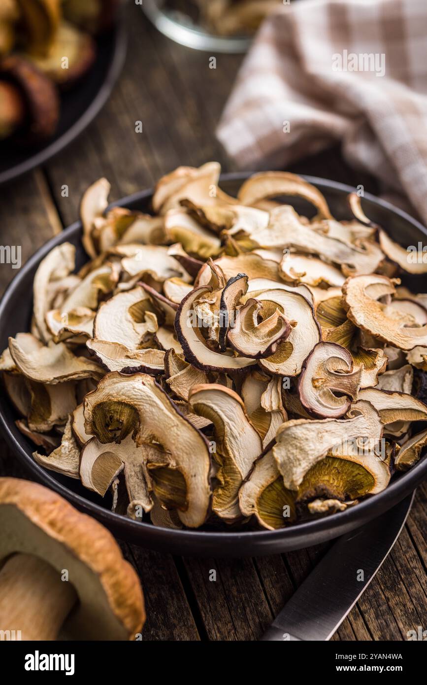 Champignons porcini séchés. Boletus tranché sur plaque sur une table en bois. Banque D'Images