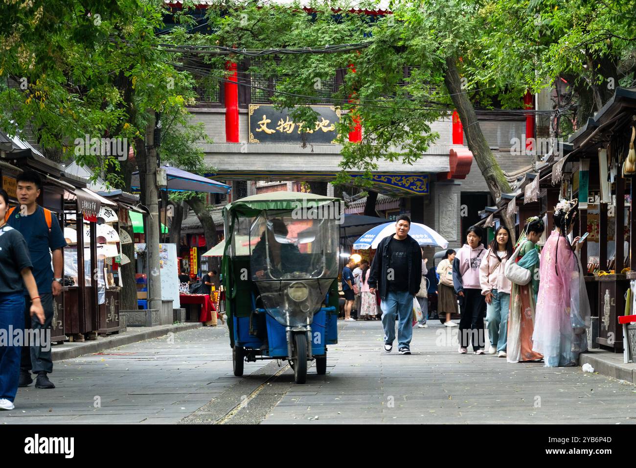 XI'an, Chine - 21 septembre 2024 : les gens marchent dans l'ancienne rue culturelle Shuyuanmen dans la vieille ville de Xi'an près de la porte de la ville Yongningmen avec le mur Banque D'Images