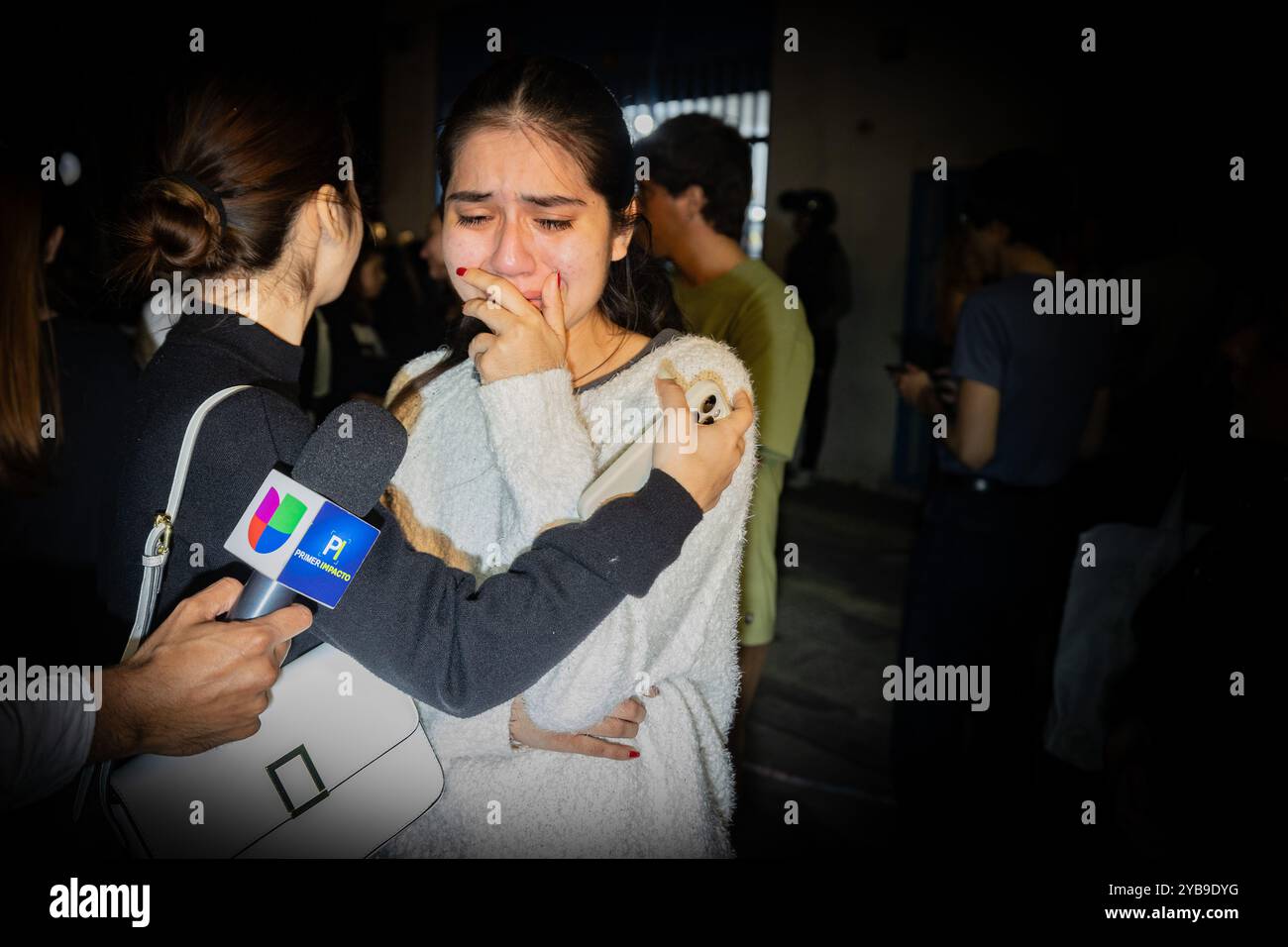 Buenos Aires, Argentine. 16 octobre 2024. Deux jeunes femmes sont interviewées alors qu'elles s'embrassent et pleurent après que le corps sans vie de Liam Payne a été emmené à la morgue judiciaire. L'ancien chanteur One Direction Liam Payne tombe du troisième étage de l'hôtel Casa sur dans le quartier de Palerme à 17 heures avant l'accident, le directeur de l'hôtel a appelé le 911 pour signaler que le chanteur détruisait la chambre, peut-être par-dessus avec de la drogue et de l'alcool. Une grande quantité de kétamine, de cocaïne rose (tusi) et d'acides ont été trouvés sur les lieux. Crédit : SOPA images Limited/Alamy Live News Banque D'Images