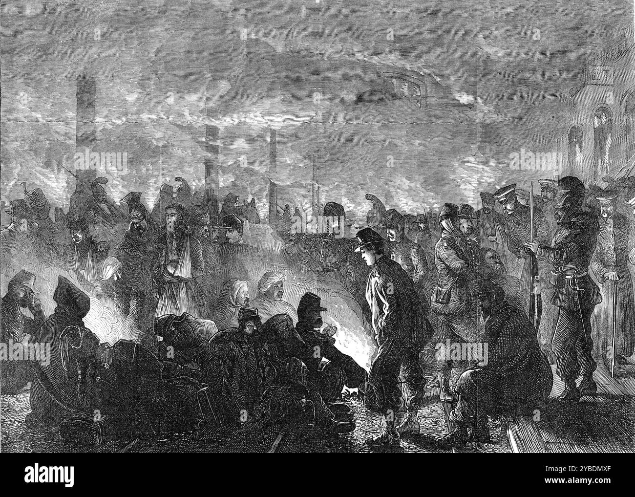 Prisonniers français à la gare d'Orléans, 1871. La guerre franco-prussienne : «...les malheureux prisonniers de guerre français, blottis ensemble à la gare d'Orléans, attendant leur départ vers le lieu destiné de leur triste détention jusqu'à la fin de la guerre. Ils étaient mal nourris et mal vêtus, et avaient terriblement souffert du froid et de la fatigue. Tiré de "Illustrated London News", 1871. Banque D'Images