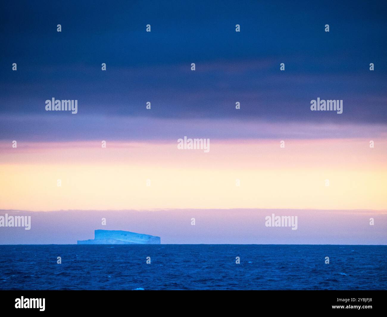 Iceberg tabulaire flottant au lever du soleil dans la mer de Écosse à l'est des îles Falkland, Atlantique Sud Banque D'Images