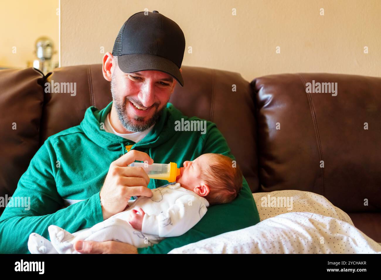 Un père heureux nourrissant son bébé garçon. Banque D'Images