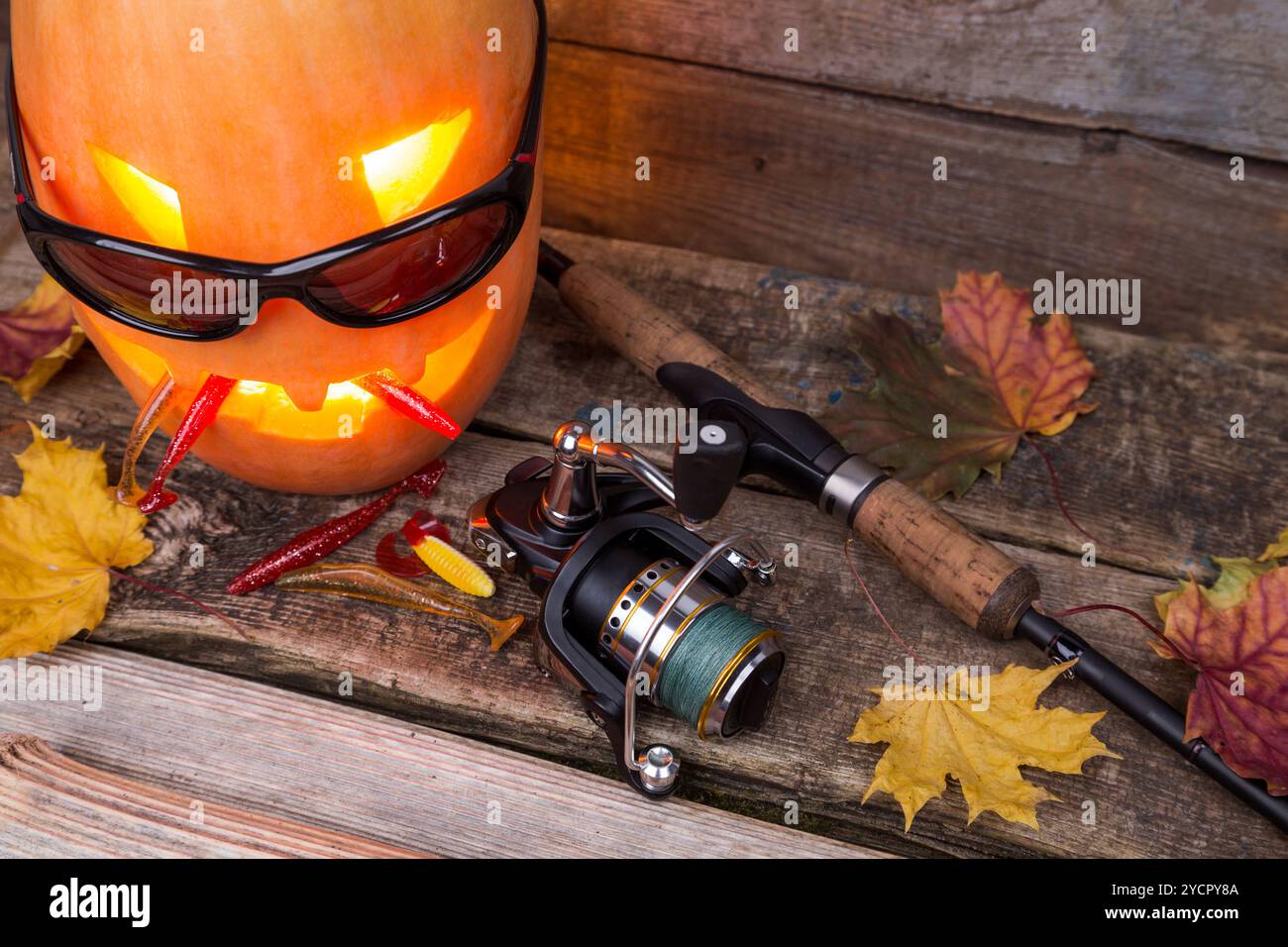 Citrouille d'Halloween dans des lunettes avec des tacles de pêche Banque D'Images Citrouille d'Halloween dans des lunettes avec des tacles de pêche Banque D'Images