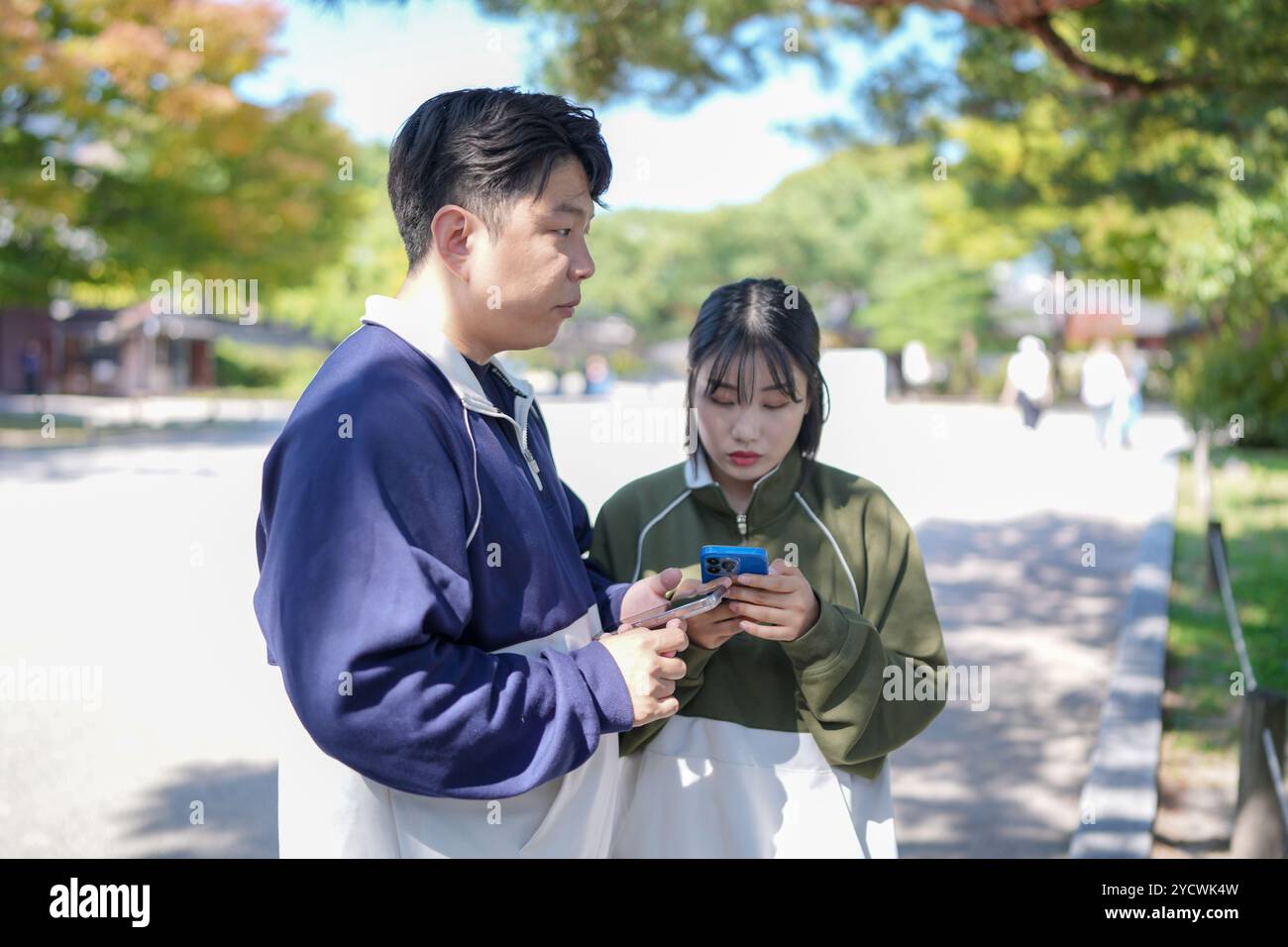 Un couple coréen sportif, un homme dans les années 30 et une femme dans les années 20, portant des survêtements, passe leur temps ensemble heureux dans un bâtiment historique en se Banque D'Images