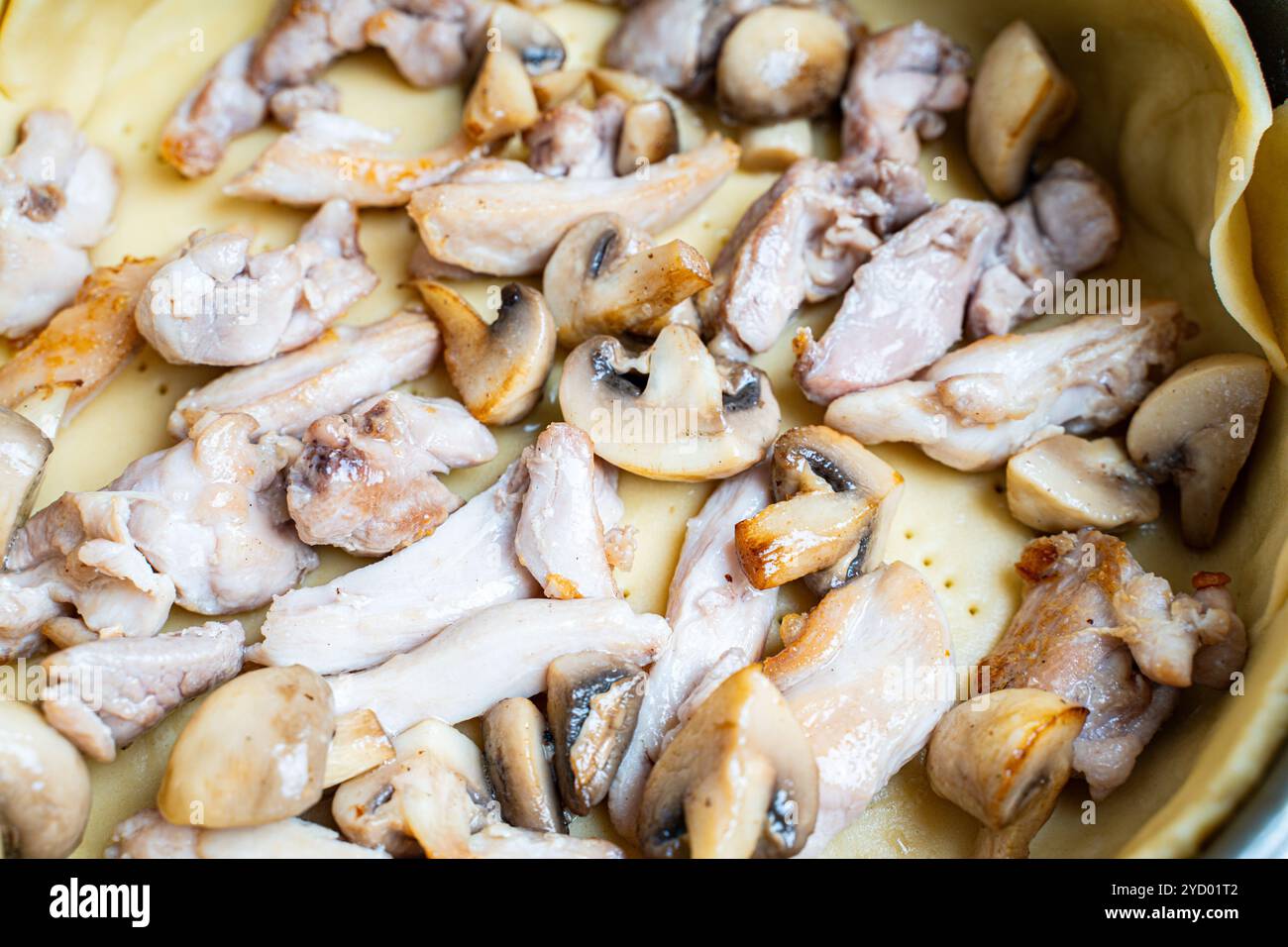 Recette Quiche loren. Mettre les morceaux de poulet frits et les champignons sur la pâte. Photo de haute qualité Banque D'Images