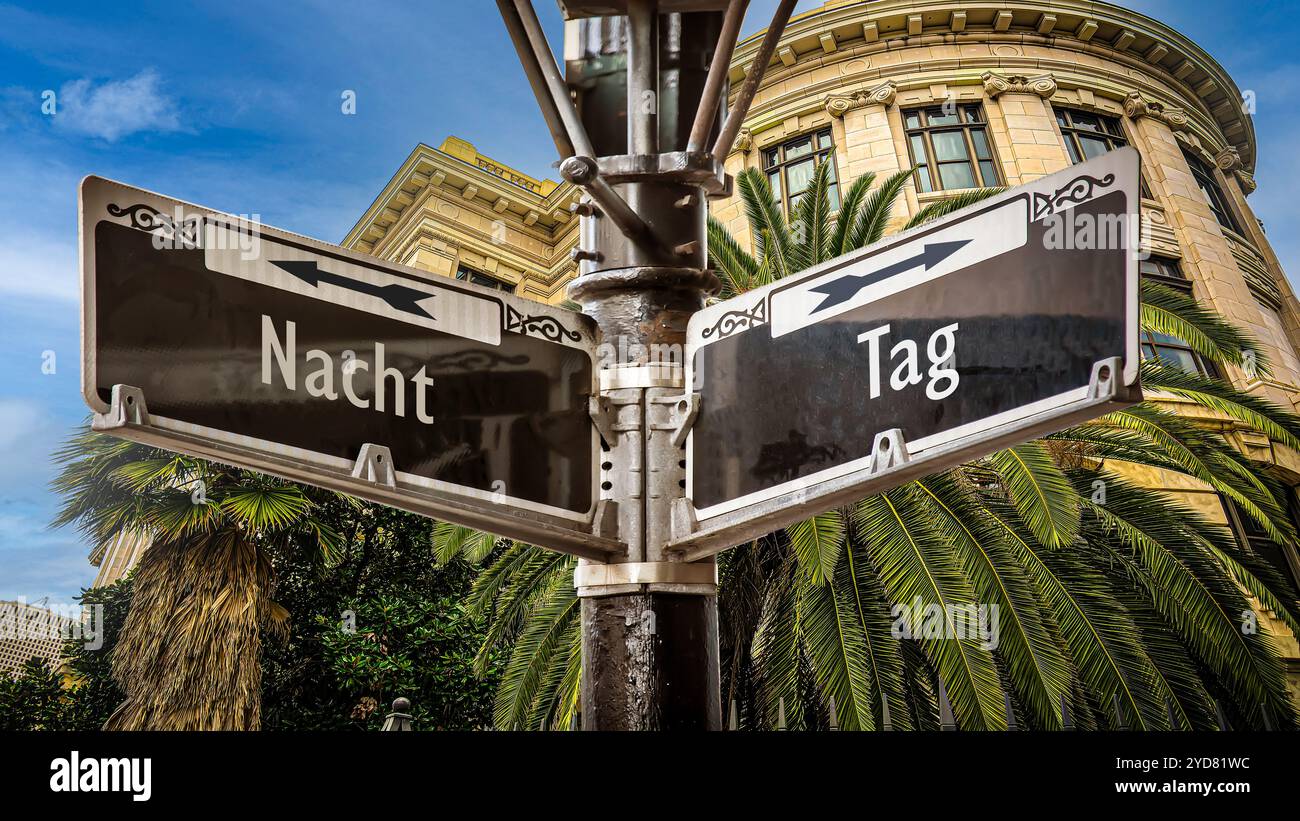 Une image avec un panneau pointant dans deux directions différentes en allemand. Une direction montre le jour, l'autre montre la nuit. Banque D'Images