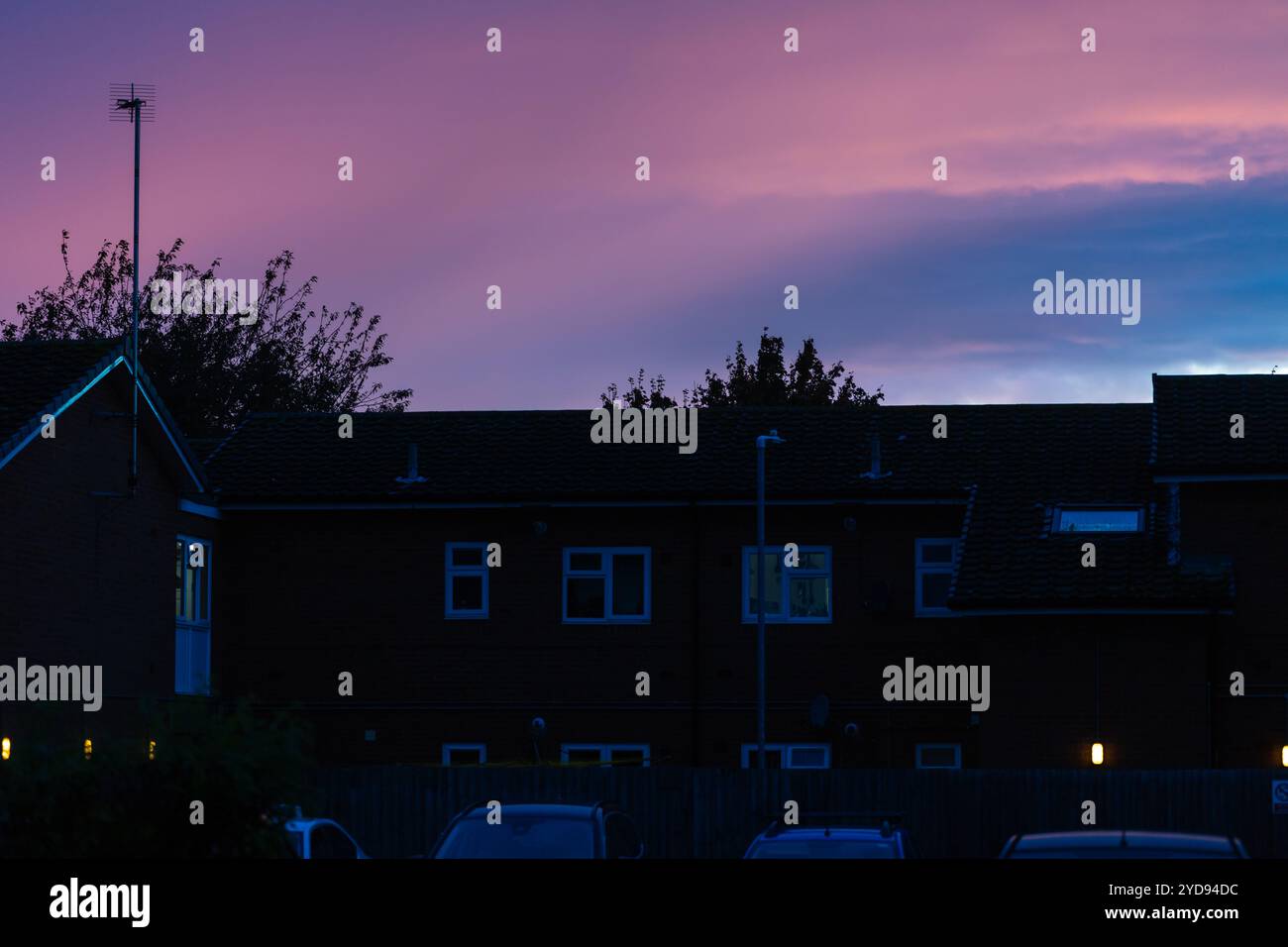 Silhouette de maisons au crépuscule avec des cieux de mauvaise humeur. Banque D'Images