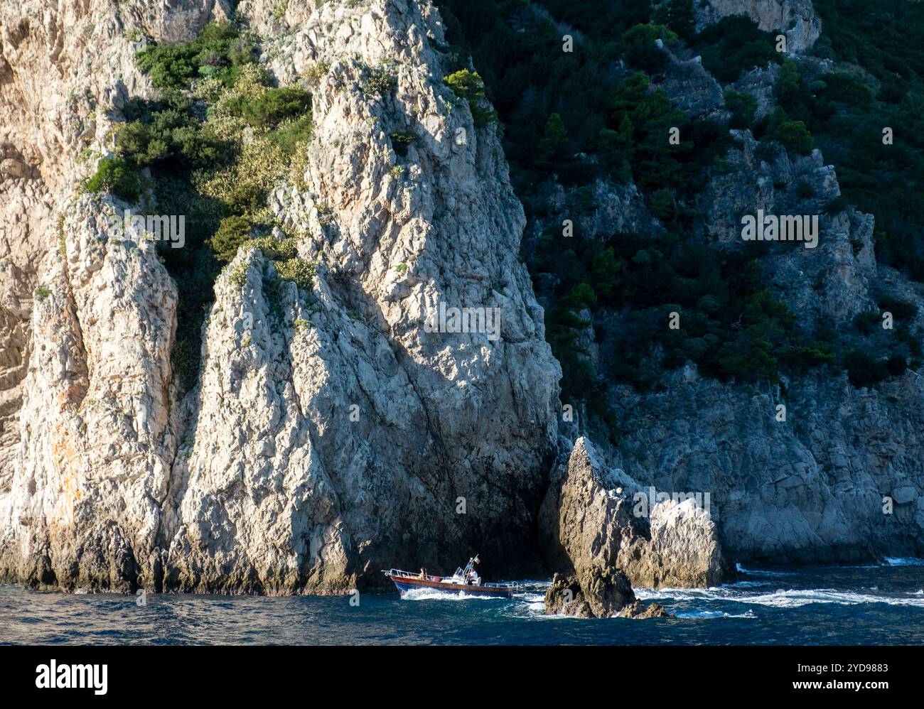 Petit bateau naviguant autour de la côte de l'île de Capri, Campanie, Italie. Banque D'Images