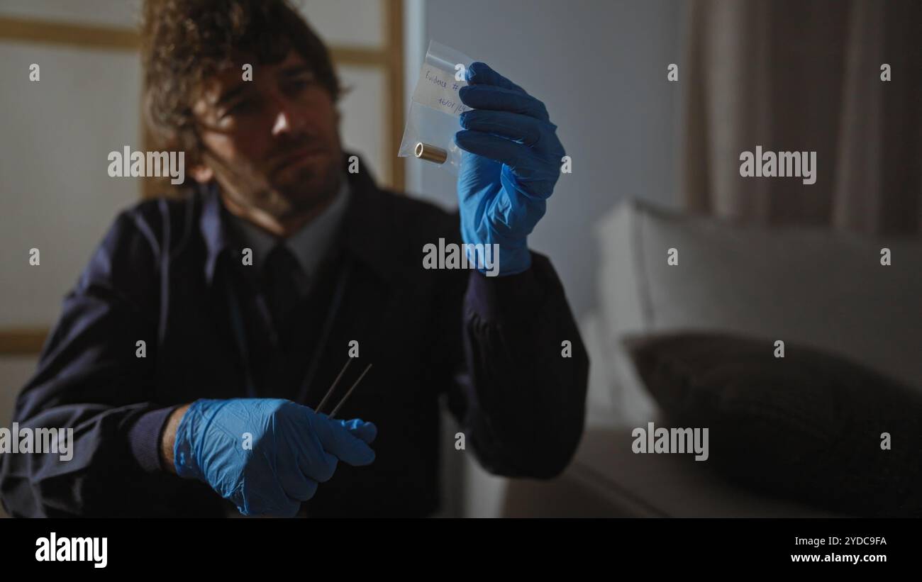 Un homme concentré examine les preuves à l'intérieur sur une scène de crime, reflétant la concentration et le travail d'enquête. Banque D'Images