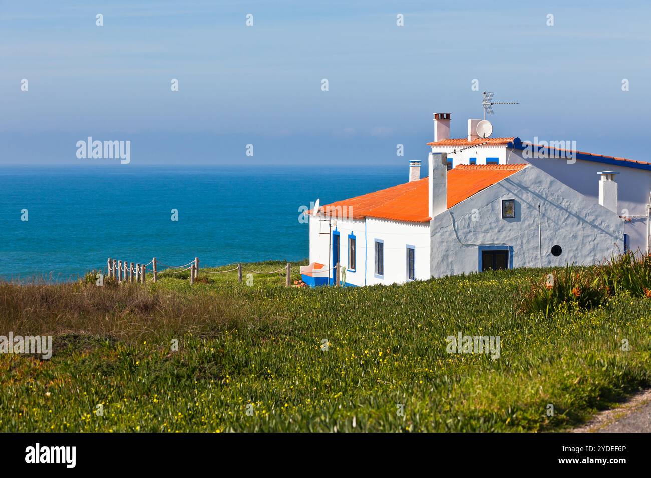 Mer turquoise, ciel bleu et maison blanche au Portugal Banque D'Images