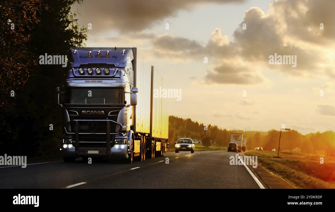 Camion Scania bleu glace personnalisé tire une remorque dans la circulation routière à l'heure du dusktime en automne. Jokioinen, Finlande. 29 septembre 2017 Banque D'Images