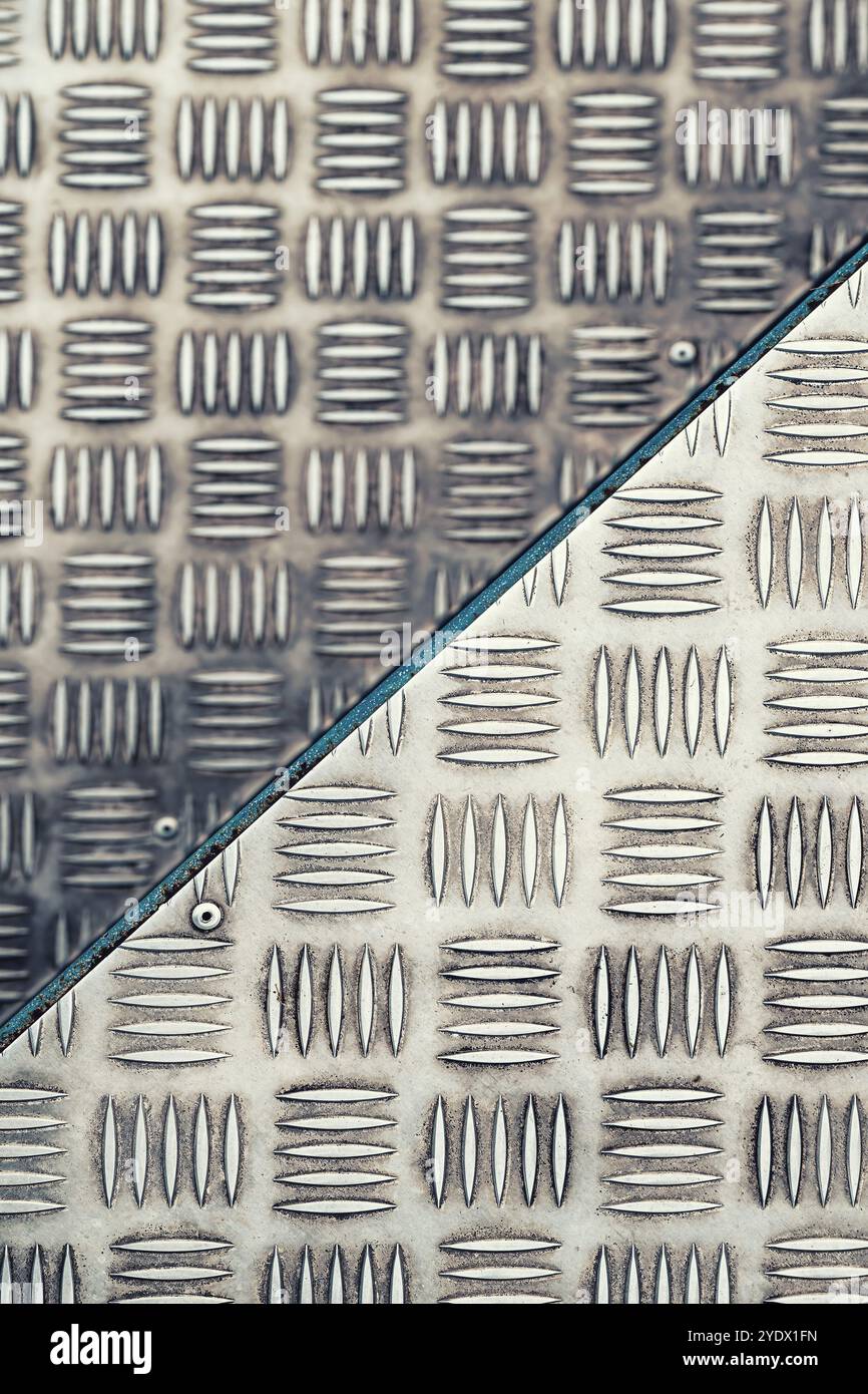 Fond abstrait, texture de l'escalier de bâtiment industriel en plaques de métal antidérapantes en acier inoxydable, mise au point sélective Banque D'Images