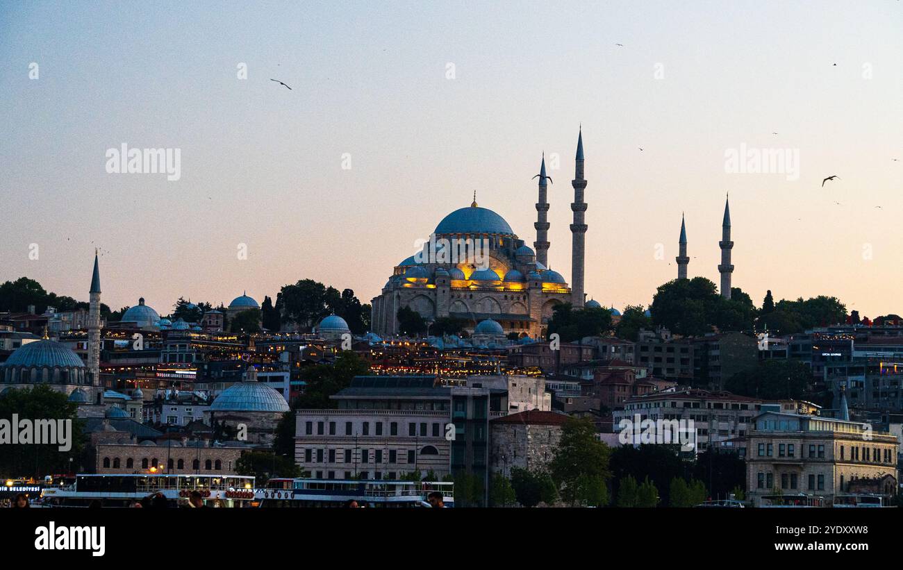 Istanbul, Türkiye : 30 juin 2024 : vue de la ligne d'horizon d'Istanbul, y compris la mosquée et le pont depuis le détroit du Bosphore pendant le coucher du soleil Banque D'Images