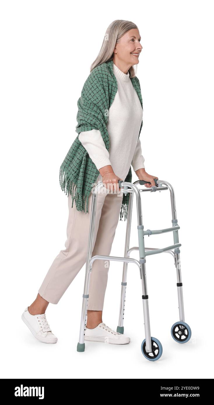 Femme senior utilisant le cadre de marche sur fond blanc Banque D'Images
