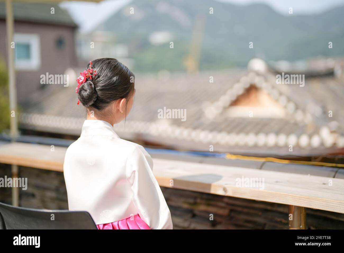 Une jeune coréenne de 9 ans portant un hanbok regarde un bâtiment traditionnel dans la ville historique de Gyedong-gil, district de Jongno, Séoul, Corée. Banque D'Images