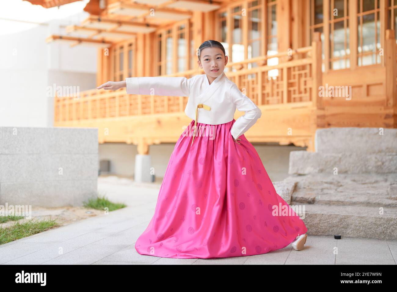 Une jeune coréenne de 9 ans portant un hanbok exécute une danse traditionnelle devant un bâtiment traditionnel dans la ville historique de Gyedong-gil, JO Banque D'Images