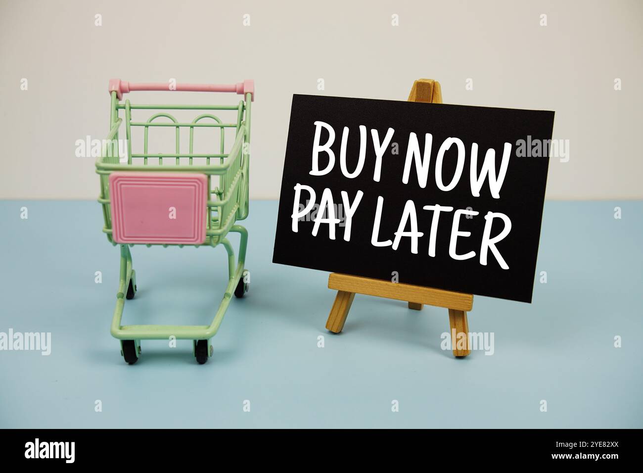 Acheter maintenant payer plus tard message texte et chariot panier sur fond bleu Banque D'Images