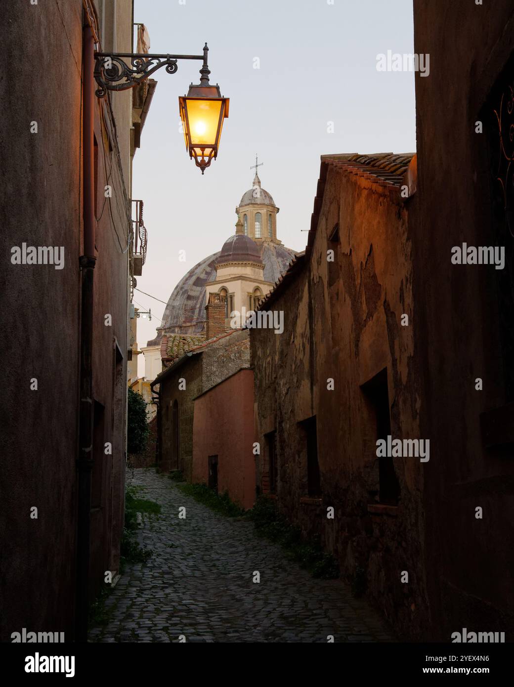 Rue étroite au crépuscule avec lampadaire et dôme de la cathédrale Montefiascone aka Basilia di Santa Margherita. Montefiascone, Italie. 01 nov. 2024 Banque D'Images