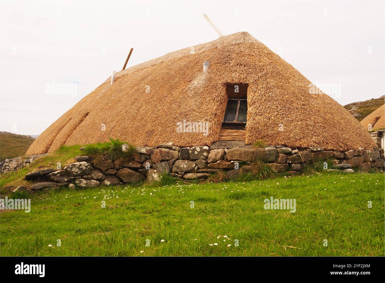 Le village de maison noire à Gearrannan sur l'île de Lewis, en Écosse. UK montrant les murs en pierre solide et les toits de chaume des habitations Banque D'Images