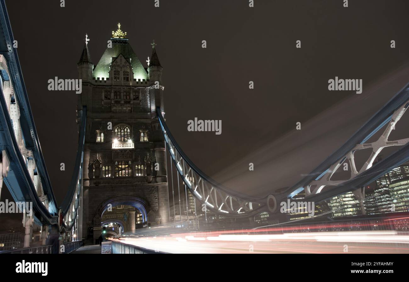 Londres, Royaume-Uni, 10 décembre 2015 : London Tower Bridge, Royaume-Uni, la nuit avec des voitures et des bus laissant des traces lumineuses colorées Banque D'Images