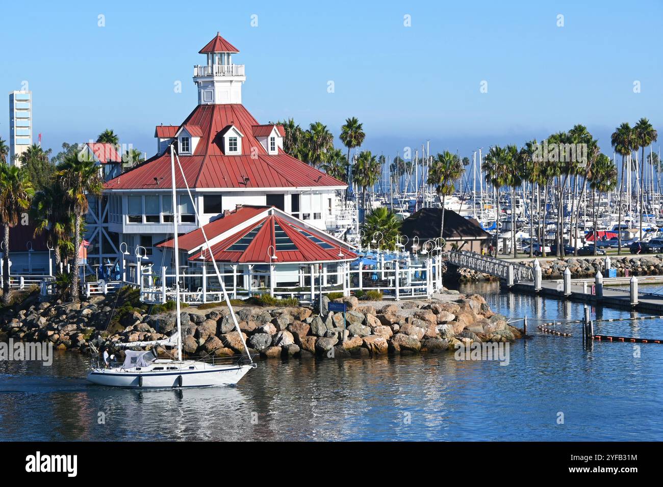 LONG BEACH, CALIFORNIE - 24 octobre 2024 : un voilier passe devant le restaurant Parkers Lighthouse à Shoreline Village. Banque D'Images