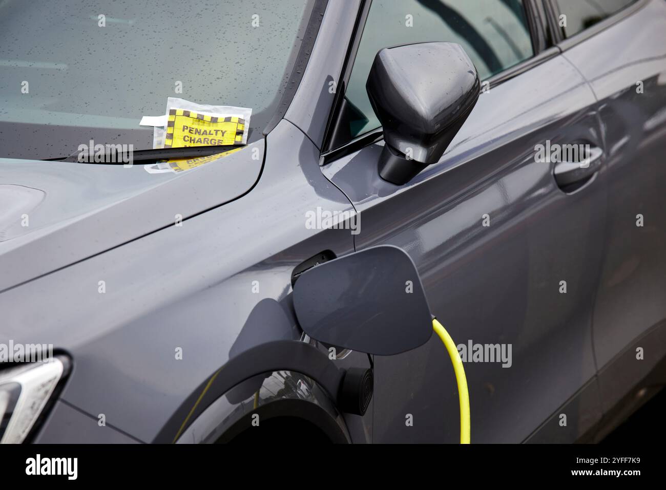 Une voiture électrique reçoit un ticket de parking au Wythenshawe Forum Banque D'Images