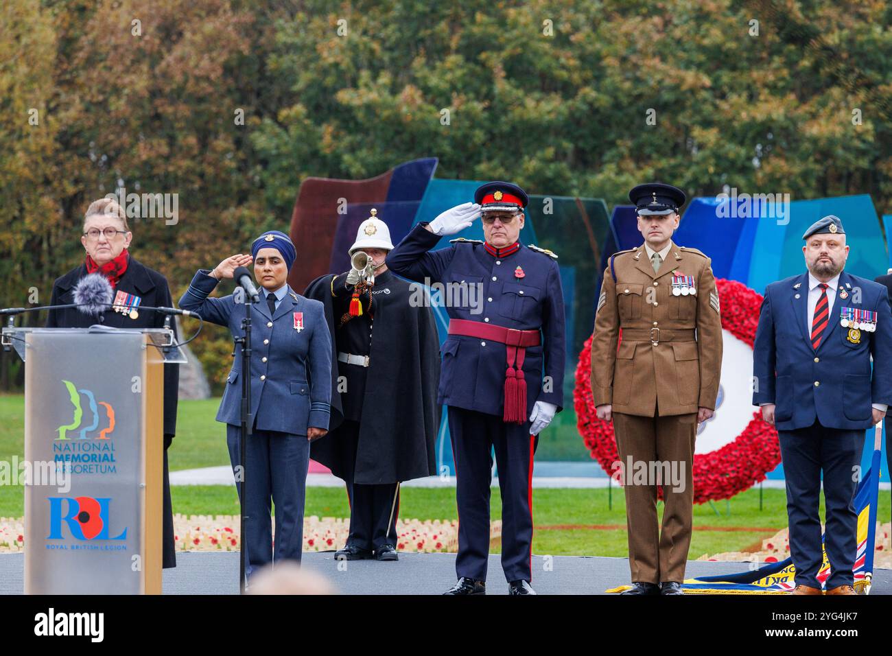 Ouverture du champ de coquelicots commémoratifs à l'Arboretum commémoratif national novembre 2024. Des coquelicots ont été placés dans le champ pour se souvenir de ceux qui ont été perdus dans les guerres mondiales et les conflits. Un service a eu lieu et deux membres du groupe 'talent in the Ranks', Lee Wright (lecture d'un poème) et Michael Lauchlan (interprétation d'une chanson) pendant le service commémoratif. Banque D'Images