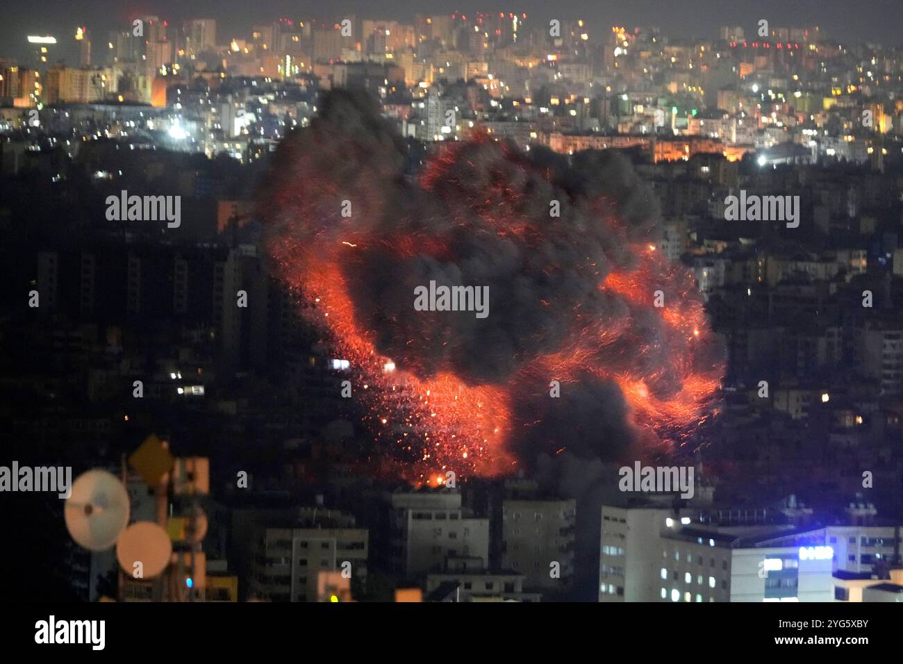FILE - Flame and smoke rises from an Israeli airstrike on Dahiyeh, in the southern suburb of Beirut, Lebanon, early Sunday, Oct. 27, 2024. (AP Photo/Hussein Malla, File) Banque D'Images