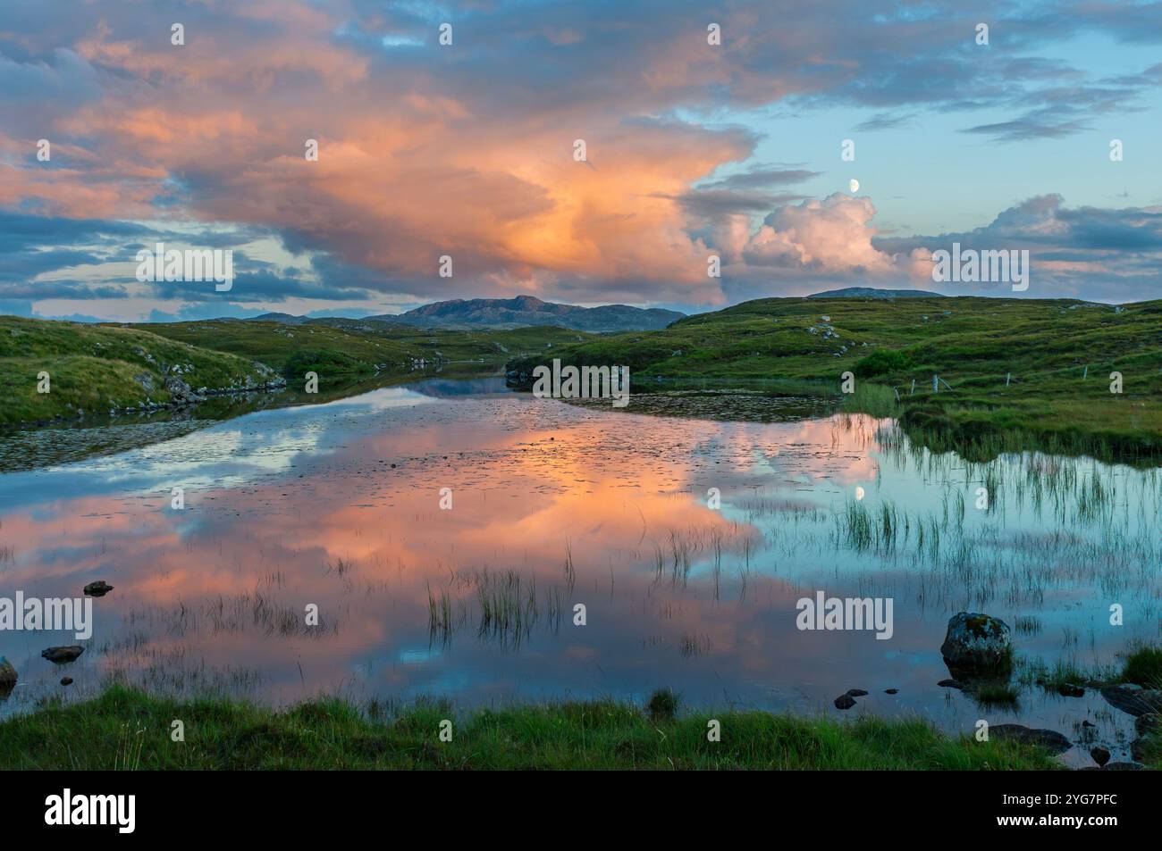 Nuages et lune reflétés dans un petit loch sur l'île de Lewis, îles occidentales, Écosse Banque D'Images