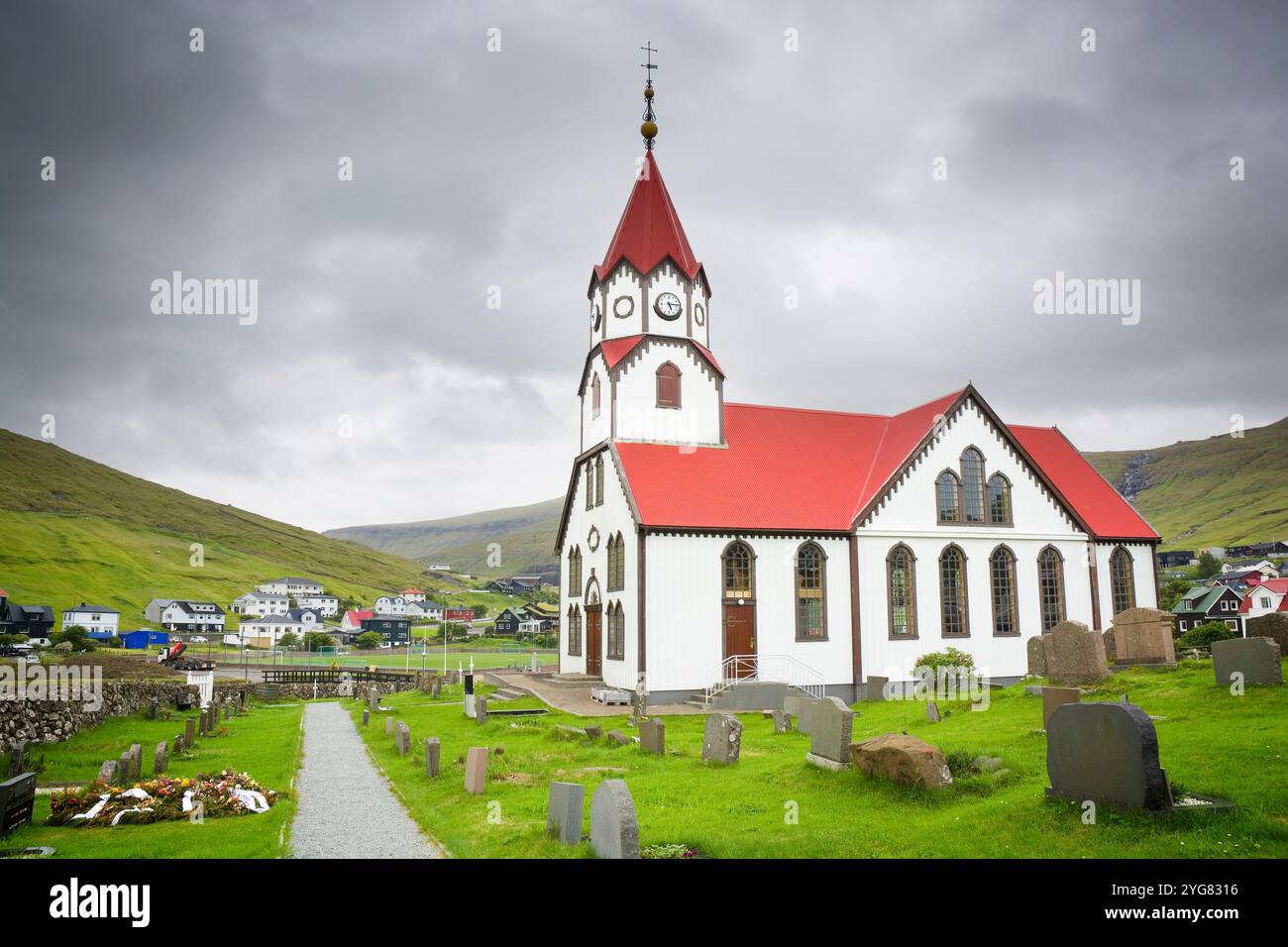 Église distinctive au toit rouge dans la ville de Sandavágur dans les îles Féroé Banque D'Images