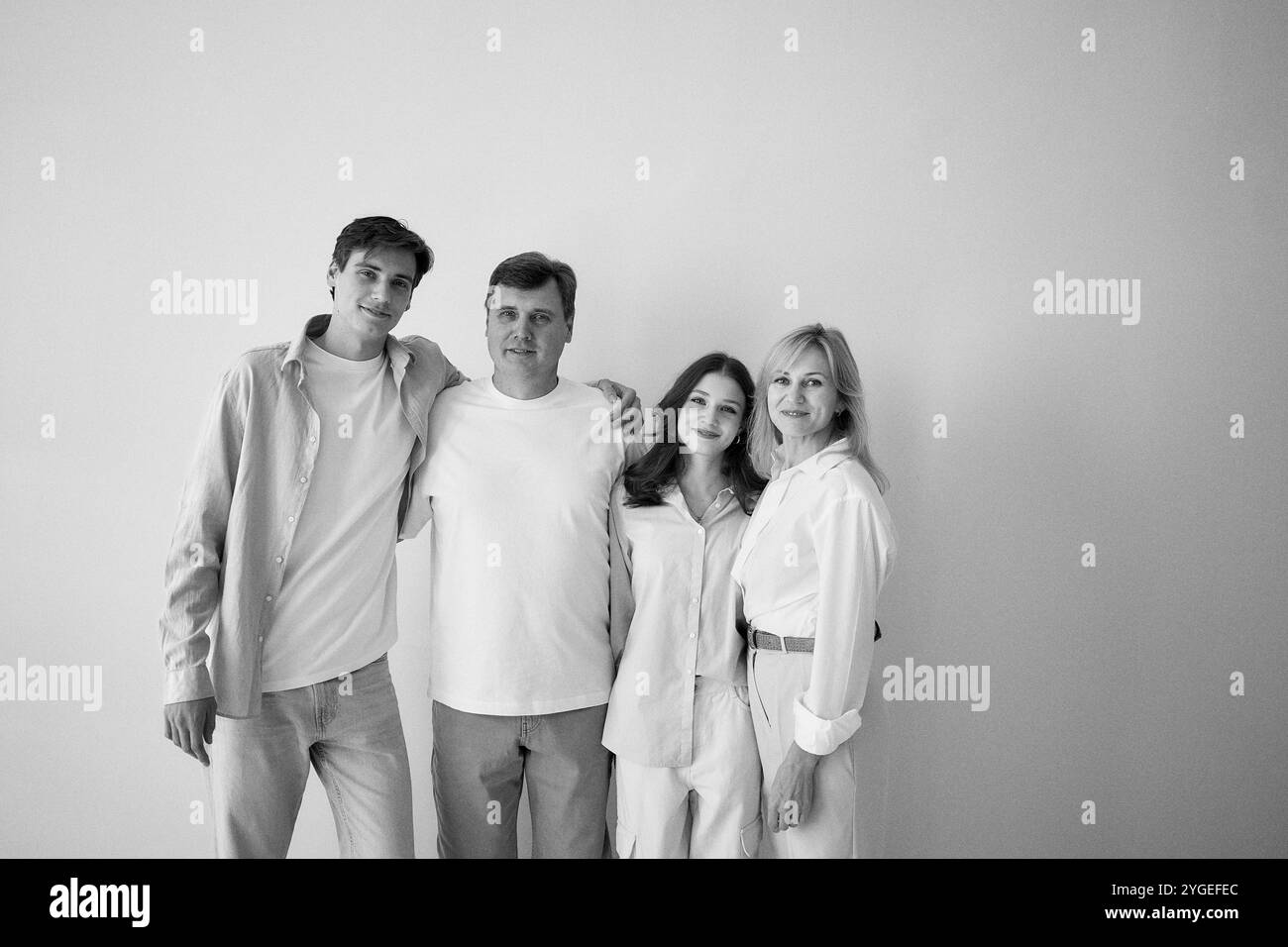 famille, mari et femme d'âge moyen, jeune fils adulte et fille adolescente, sur fond blanc, séance photo en studio Banque D'Images