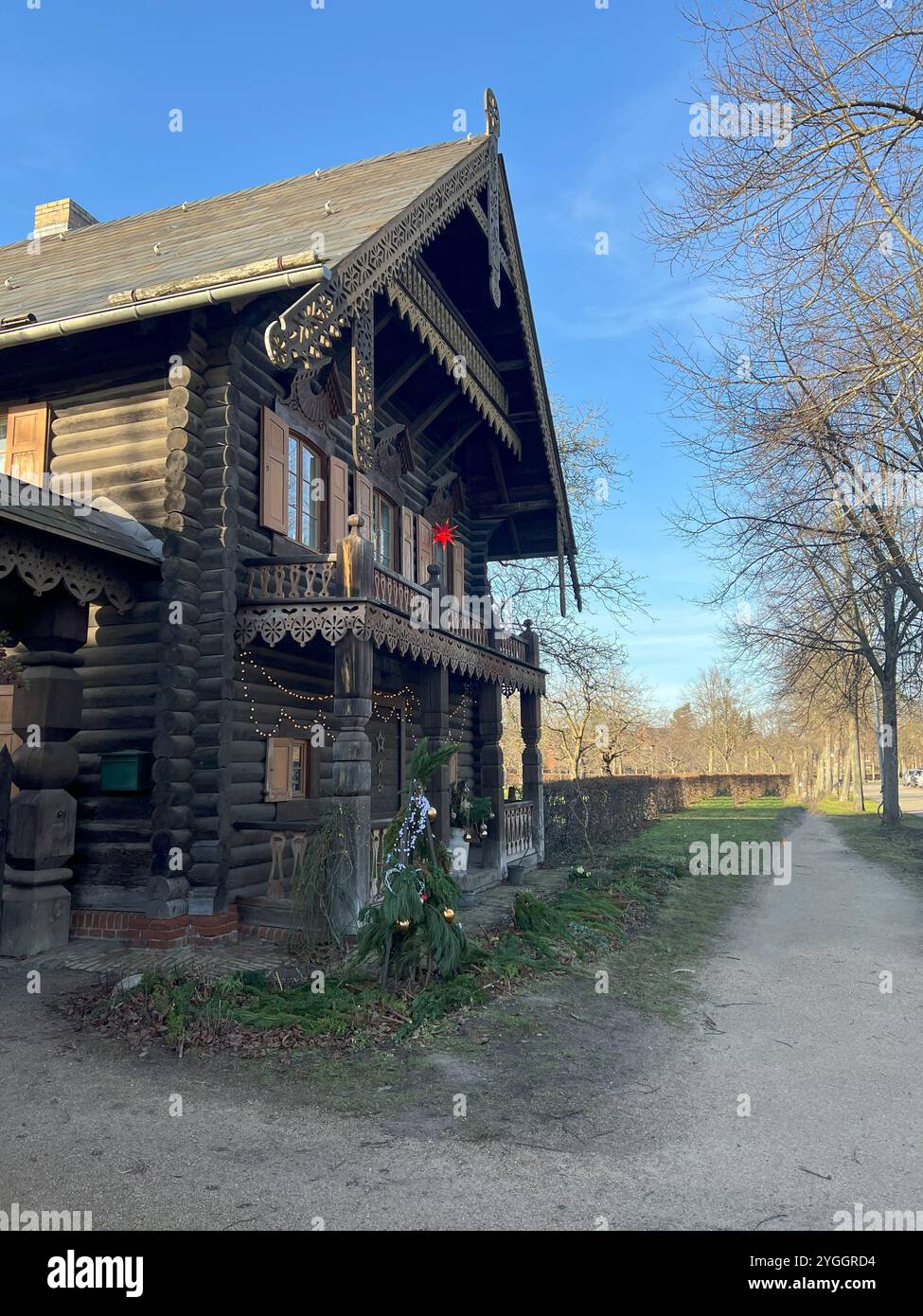 Cette photo montre le musée Alexandrowka de Potsdam, mettant en valeur son architecture traditionnelle en bois de style russe entourée d'une végétation luxuriante. Banque D'Images