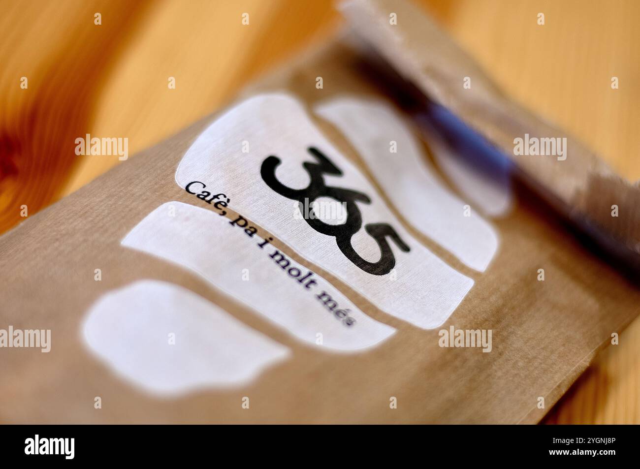 Viladecans. Espagne - 08 novembre 2024 : gros plan d'un sac en papier de café de 365 sur une surface en bois, mettant en évidence le logo et le design du café. Parfait pour une utilisation i Banque D'Images