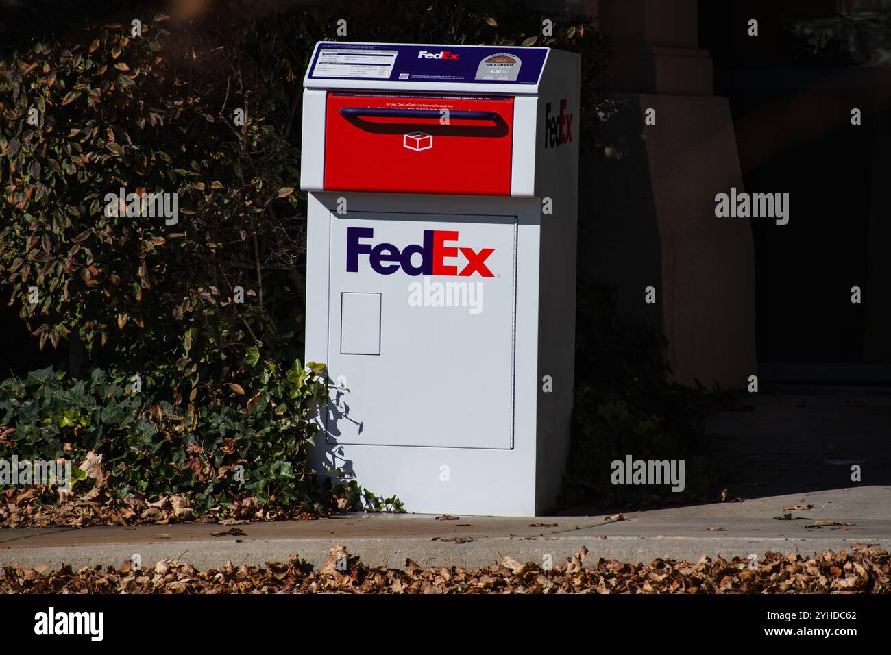 Une boîte de dépôt FedEx se tient contre un mur d'un immeuble de bureaux. Les boîtes de dépôt FedEx Express acceptent une variété de colis et d'enveloppes. Banque D'Images