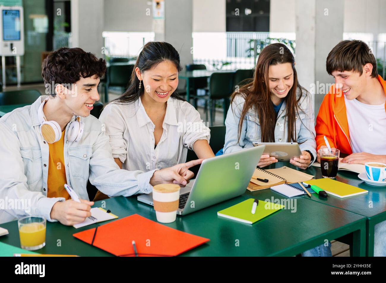 Divers groupes d'étudiants étudient ensemble à la cafétéria de l'université Banque D'Images