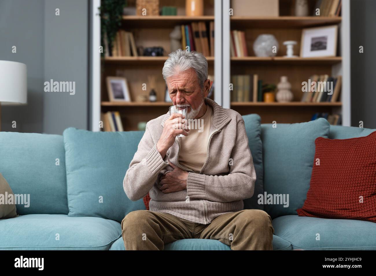 Homme âgé, veuf ou divorcé, se sentant triste, inquiet, abandonné et déprimé, assis seul à la maison, en pleurant. Solitude et tristesse du mâle âgé avec Banque D'Images