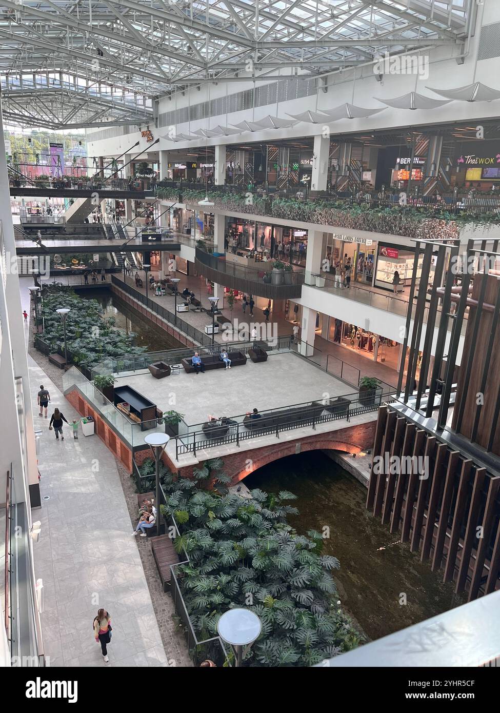 Traversée de la rivière à l'intérieur de l'intérieur du centre commercial Forum Gdansk à Gdansk, Poméranie, Pologne, Europe, UE - Image de stock capturée avec un smartphone