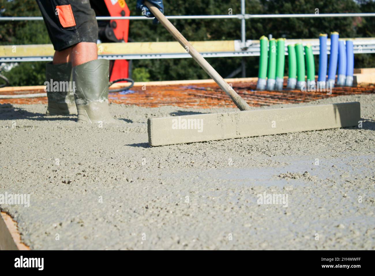 Ouvriers remplissant le sol du deuxième étage avec le béton, le noyau et le bâtiment de construction de coquille Banque D'Images