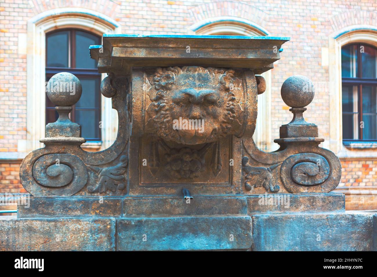 Fontaine en pierre avec une tête de lion, élégamment conçue avec de l'eau courante. Fontaine publique Baroque Carrati à Prague. Carratiho Kasna Banque D'Images