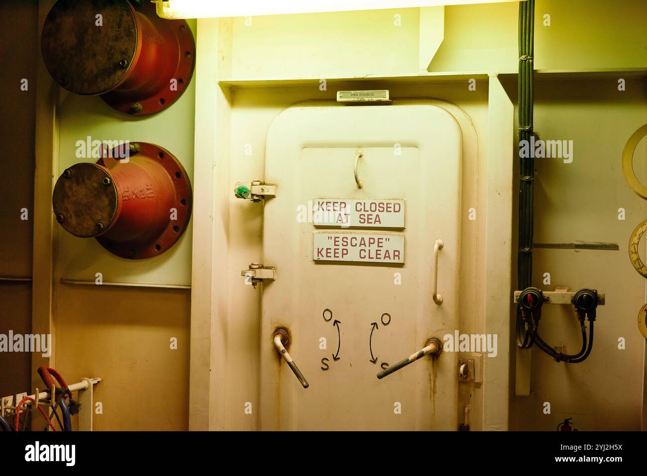 Porte étanche sur un navire avec lecture des instructions de sécurité GARDER FERMÉ EN MER et ÉCHAPPER pour assurer la sécurité et la sensibilisation aux situations d'urgence. Banque D'Images