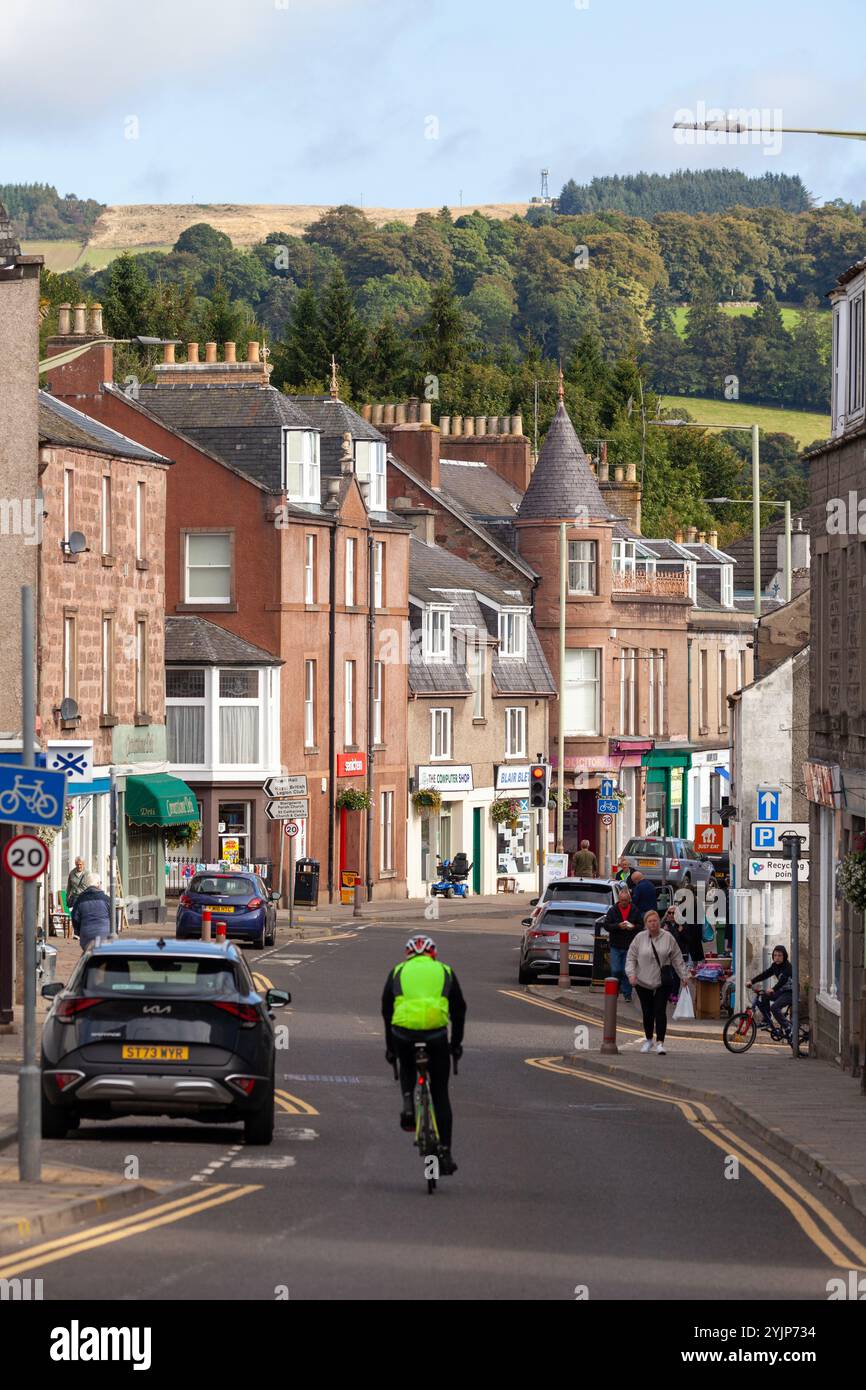 Un cycliste descendant Blairgowrie High Street, Perthshire, Écosse Banque D'Images