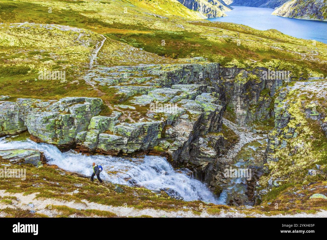 Jeune randonneur et magnifique paysage d'été panorama avec montagnes rivière lac rochers et sentier de randonnée du parc national de Rondane à Ringbu Innlandet Norw Banque D'Images