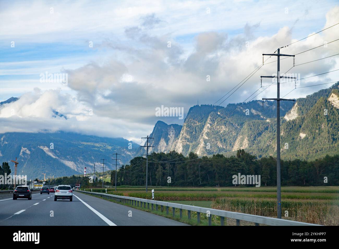 Une route sinueuse le long de lignes électriques, à travers les montagnes alpines menant de l'Italie à l'Allemagne en passant par la Suisse Banque D'Images