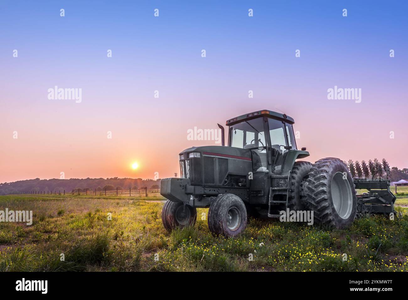 Tracteur agricole dans un champ sur une ferme du Maryland au coucher du soleil Banque D'Images
